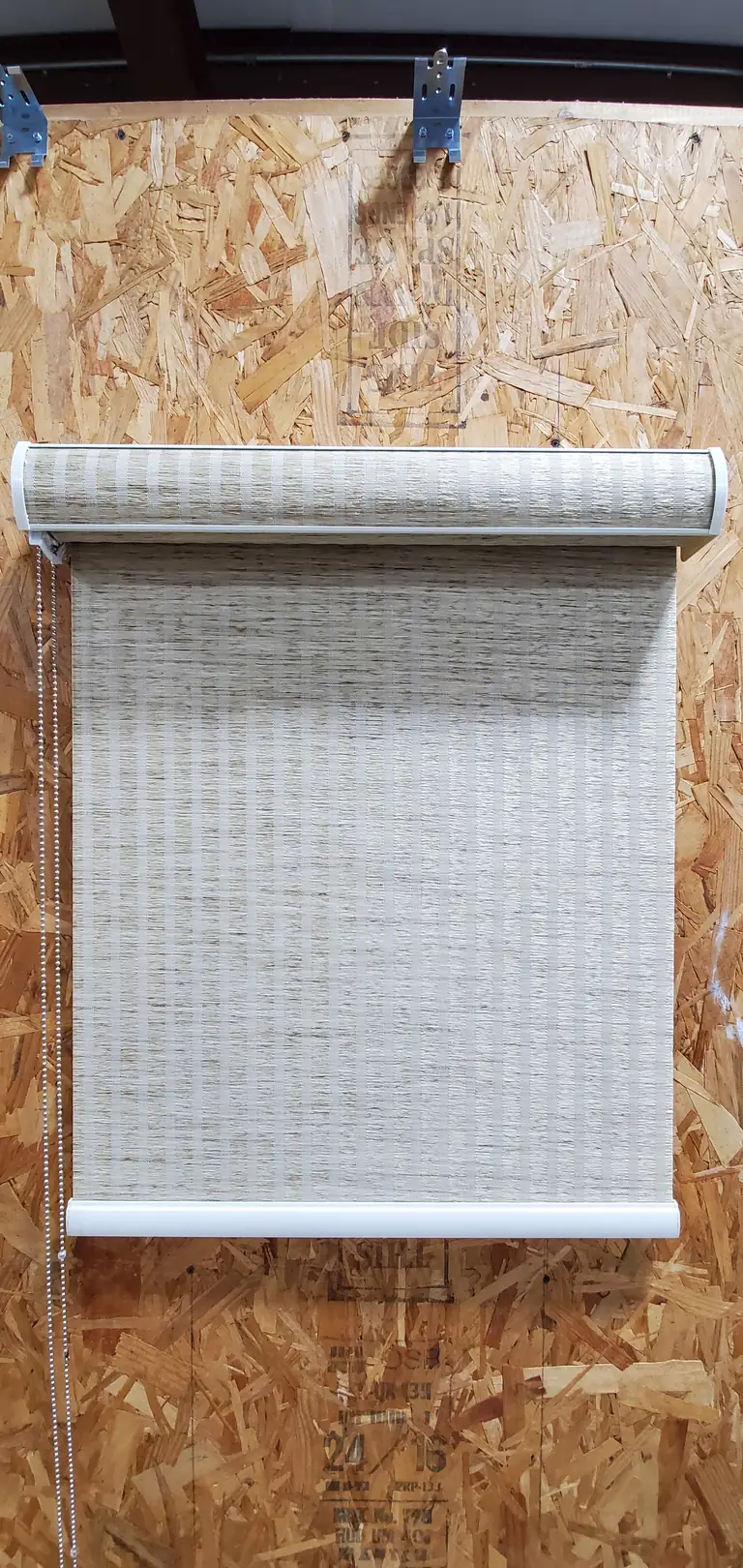 Fabric and material samples mounted on the workshop wall at the Pangburn shop